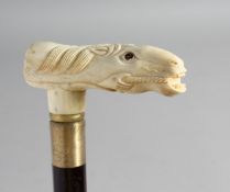 A WALKING STICK with carved bone handle of a horse.