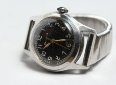 A BULBOUS MILITARY WRIST WATCH.