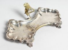 A GEORGE II SHAPED SNUFFER TRAY crested with shell mounts on four curving feet. 7.5ins long.