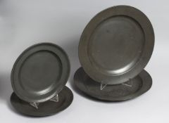 FOUR 19TH CENTURY PEWTER PLATES, two 9ins diameter, two 12ins diameter.