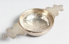 A GOOD GEORGE III TWO HANDLED LEMON STRAINER. London 1727. Maker Possibly Jason Smith.