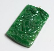 A GOLD TOP CARVED JADE PENDANT.