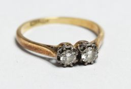 AN 18CT GOLD TWO STONE DIAMOND RING.