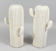 A PAIR OF WHITE PORCELAIN CACTUS VASES. 15ins high.