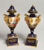 A SUPERB PAIR OF 19TH CENTURY VIENNA URNS VASES, COVERS AND STANDS, rich blue ground decorated in