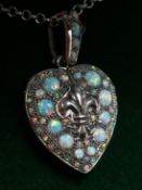 A SILVER AND OPAL HEART SHAPED LOCKET AND CHAIN.