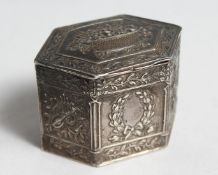A SMALL DUTCH SILVER HEXAGONAL BOX with chased panels, the lid decorated with a basket of flowers.