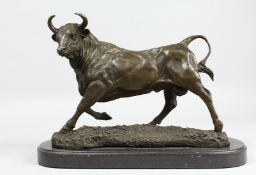 A LARGE SPAINISH BRONZE BULL on a marble base. 12ins long.