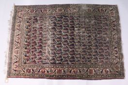 AN EARLY 20TH CENTURY PERSIAN RUG, dark blue ground with stylized Botek decoration (worn). 5ft