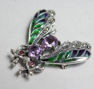 A SILVER AND AMETHYST BUG BROOCH.