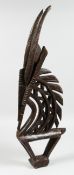 A BAMBARRA PIERCED AND CARVED WOODEN HEAD DRESS, 31ins long.