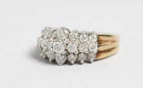 A 9CT GOLD THREE ROW DIAMOND RING.
