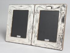 A PAIR OF SILVER AND ENAMEL PHOTOGRAPH FRAMES. 7.5ins x 5.5ins.
