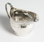 A GEORGE III CREAM JUG. London 1809.