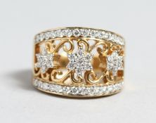 A GOOD 18CT GOLD TRIPLE FLOWER DIAMOND CLUSTER RING.