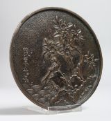 A RARE 17TH CENTURY SILVERED BRONZE CIRCULAR MIRROR. 1596 - 1615. 4.5ins diameter.