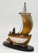 A GOOD PALAIS ROYAL MOTHER OF PEARL SHELL BOAT on a black oval base. 20cm long.