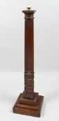 A CARVED AND FLUTED OAK COLUMN on a lamp base.