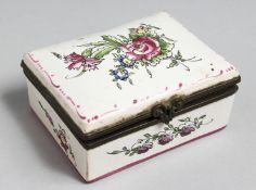 A FRENCH FAIENCE TABLE SNUFF BOX painted with flowers. 3.5ins long.