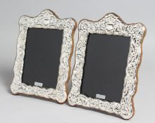 A PAIR OF SILVER AND ENAMEL PHOTOGRAPH FRAMES. 7.5ins x 5.5ins.