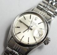 A LADIES ROLEX OYSTER PERPETUAL DATE CHROME WRIST WATCH in a Rolex box.