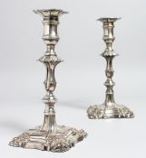 A PAIR OF GEORGIAN PLATE CANDELSTICKS. 9ins high.
