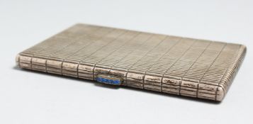 A RIBBED SILVER CIGARETTE CASE with sapphire clasp.