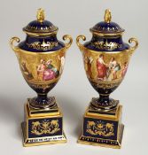 A VERY GOOD PAIR OF 19TH CENTURY VIENNA URN SHAPED VASES, COVERS AND STANDS, rich blue ground