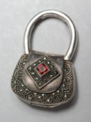 A SILVER HANDBAG PENDANT.