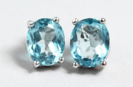 A PAIR OF SILVER AND BLUE TOPAZ EARRINGS.
