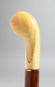 A WALKING STICK WITH CARVED IVORY HANDLE.