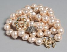 A GOOD CHANEL LONG LARGE PEARL NECKLACE with two intwined enamel 'C's'.