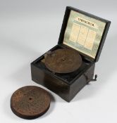 A 19TH CENTURY GERMAN SYMPHONIUM with TWELVE 5.5 discs in a faux rosewood case 7.5ins x7.5ins.