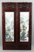 A PAIR OF CHINESE PORCELAIN HANGING PLAQUES in wooden frames. 11ins long.