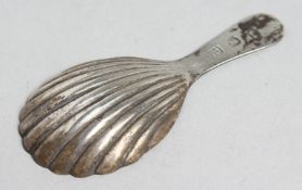 A GEORGE III SHELL SILVER CADDY SPOON.