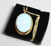 A 9CT GOLD GILSON OPAL PENDANT AND CHAIN.