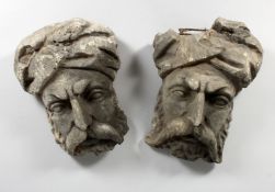A PAIR OF CARVED STONE TURK'S HEAD. 11ins long.