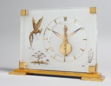 A GOOD JAEGER-LECOUTRE PERSPEX AND GILT CLOCK, No. 350, with a dragon fly on brass bracket feet. 6.
