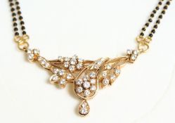 A 22CT GOLD, DIAMOND SET PENDANT on an gold chain.