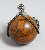 A GEORGIAN NUT AS A SCENT BOTTLE etched with a man and woman with a silver stopper and chain.