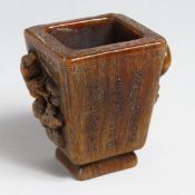 A HORN TAPERING LIBATION CUP with animals handles and caligraphy, 4.75ins high.