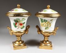 A PAIR OF PORCELAIN URN SHAPED VASES AND COVERS painted with fruit. 14ins high.