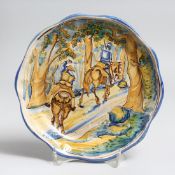 A SMALL ITALIAN MAJOLICA CIRCULAR PLATE with two soldiers on horseback in a wooded glade. 8ins