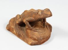 A CARVED WOOD FROG. 7ins long.
