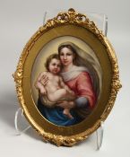 A GOOD 19TH CENTURY CONTINENTAL PORCELAIN OVAL GILT FRAMED PLAQUE, Madonna and child. 9ins x 7ins.