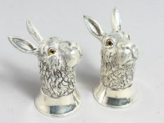 A PAIR OF .800 WHITE METAL RABBIT SALTS AND PEPPERS.