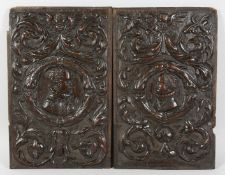 A GOOD PAIR OF CARVED OAK 17TH - 18TH PANELS with masks, scrolls and cupids. 19ins x 12ins.
