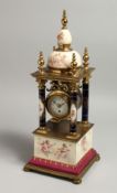 A VERY GOOD 19TH CENTURY VIENNA PORCELAIN CLOCK with four column supports and painted with cupids.