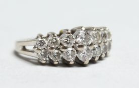A 14CT WHITE GOLD TWO ROW DIAMOND RING.