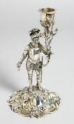 A RARE VICTORIAN CAST SILVER KNIGHT TAPERSTICK as a knight holding a sconce. London 1865. Maker